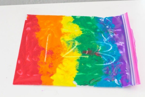 Practice writing letters and numbers on the rainbow bag writing tray.