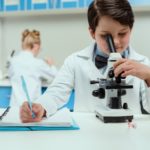 Boy and girl in lab coats in science lab