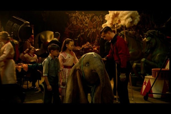 Dumbo movie still of Dumbo with children and Holt Farrier at the circus.