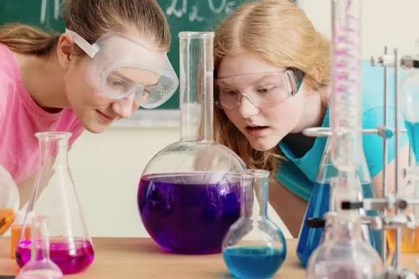Two teenage girls conducting chemistry experiment