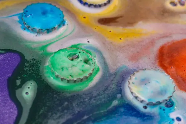 Close up of the baking soda and vinegar reaction during fizzy bottle caps science activity for kids