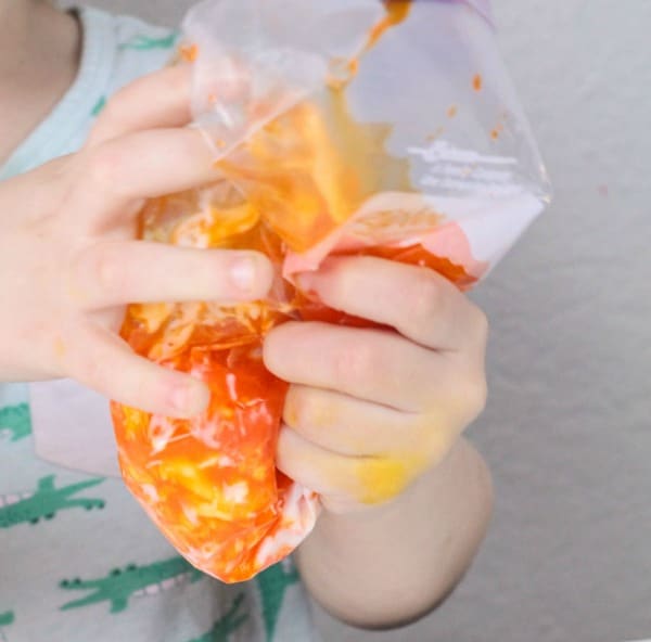 Close up of kid mixing up slime putty ingredients in bag