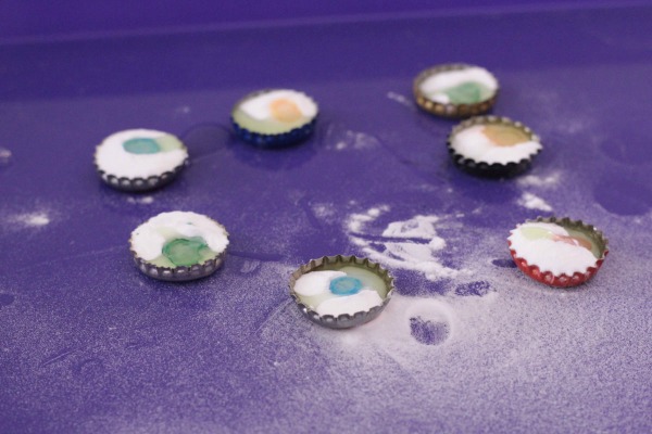 How to set up the fizzing bottle caps science activity for kids.