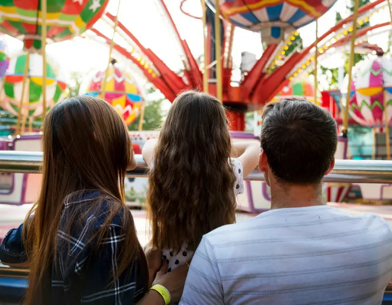 Family looking at a ride at a theme park.