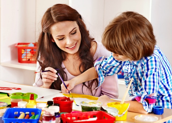 Mom and son painting and crafting together.