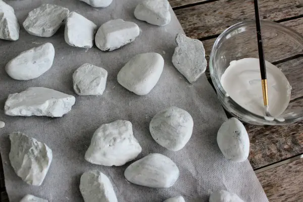 Rocks painted white and drying