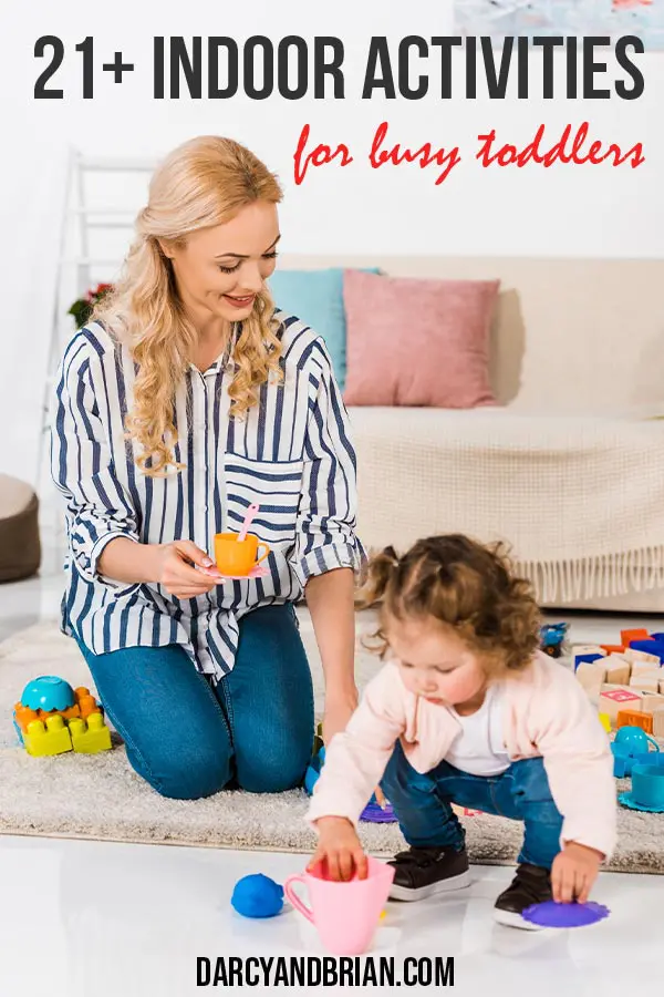 Mom with blond hair playing with toddler in living room