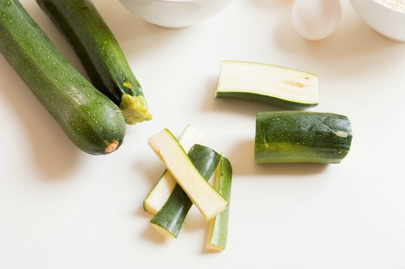 Zucchini cut in strips on white background