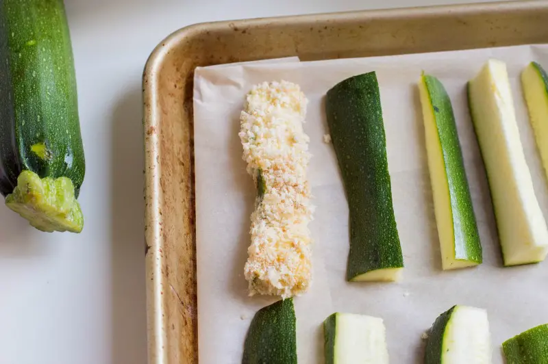 Zucchini fries laid out on baking tray