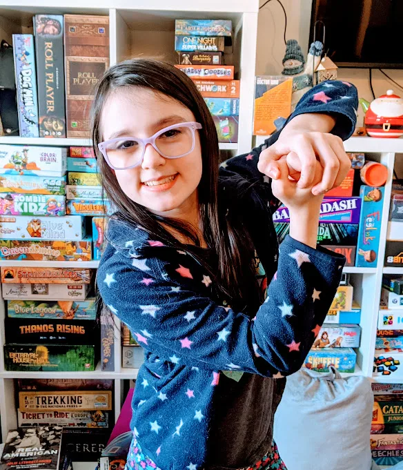 Author's daughter posing with an imaginary sword while playing charades.