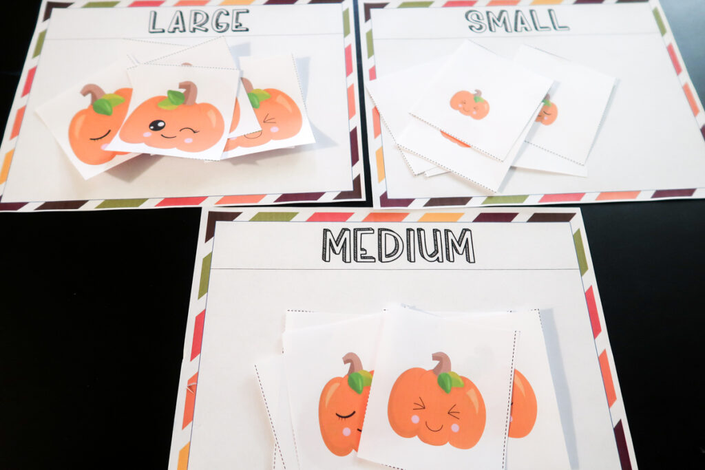 Pumpkin cards in different sizes sorted on size mats labeled Large, Medium, Small.