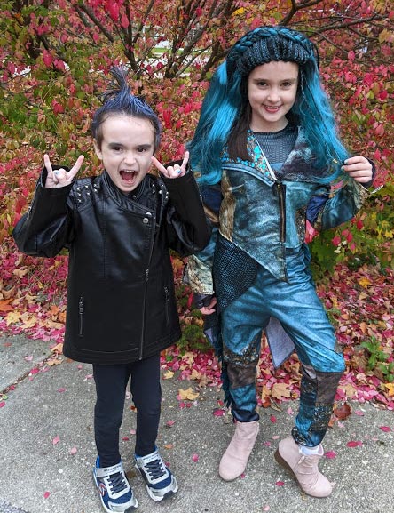 Boy dressed up as Hades and girl dressed up as Uma characters from Descendants 3 movie.