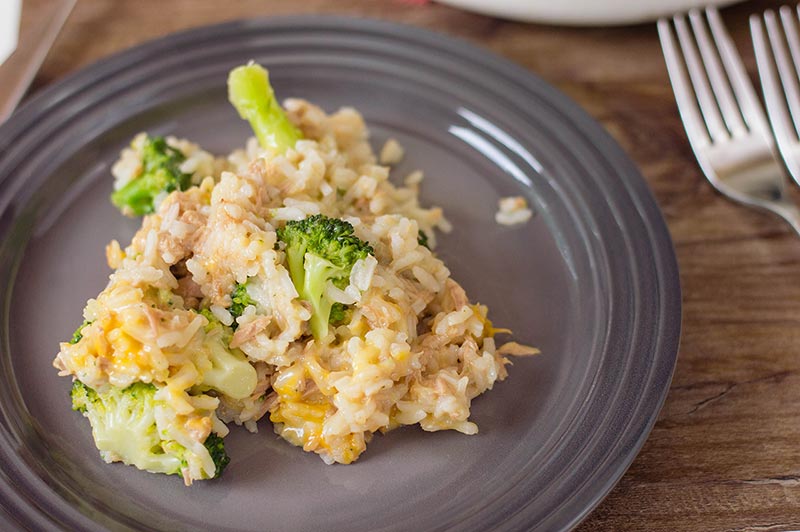 Tuna and rice with cheese and broccoli served on gray plate