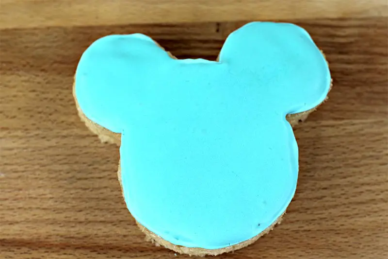 Mickey Ears shaped rice crispy treat with light blue icing covering the top.