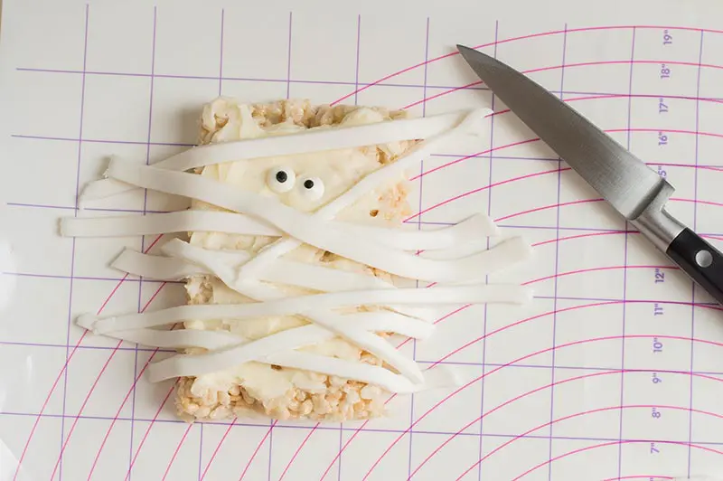 Decorating rice crispy treat with fondant to look like a mummy