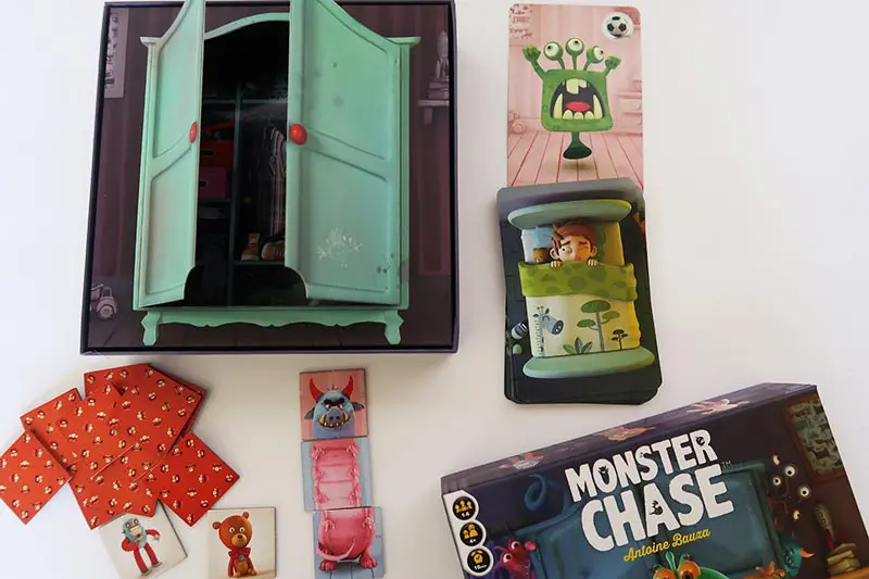 Monster Chase board game for kids game pieces on table.