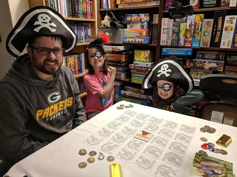 Family dressed as pirates playing Memoarrr game.