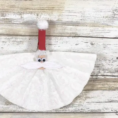 Finished Santa craft made with coffee filter and clothespin.