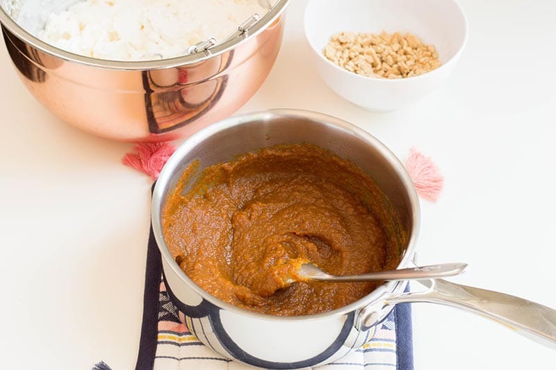 Heating pumpkin puree and other ingredients in saucepan.