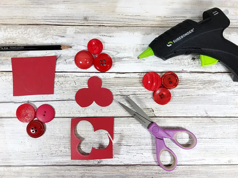 Craft tutorial showing steps for tracing buttons on red card stock paper and gluing them.