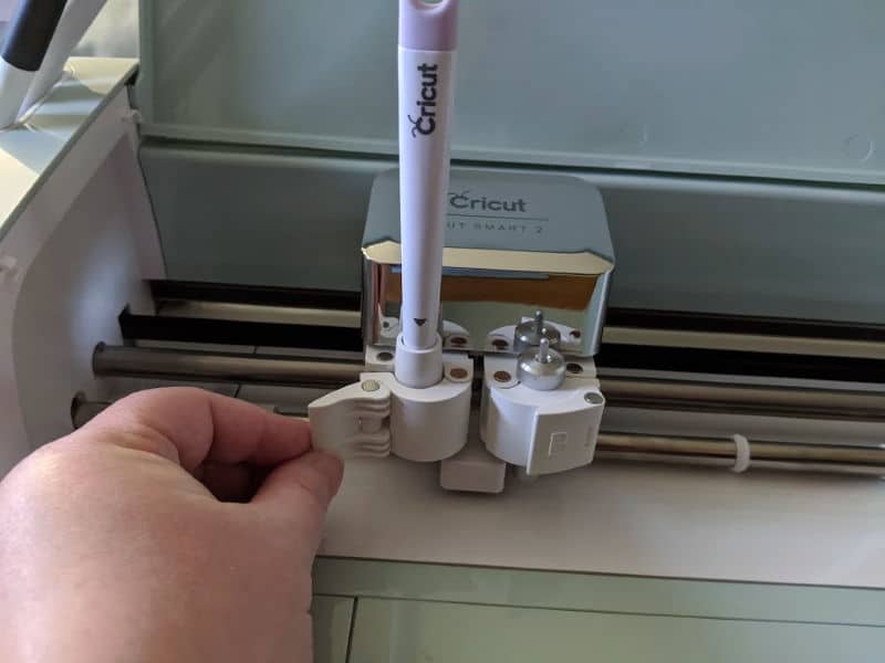 Close up of scoring stylus placed in Clamp A on Cricut Explore Air 2 machine.
