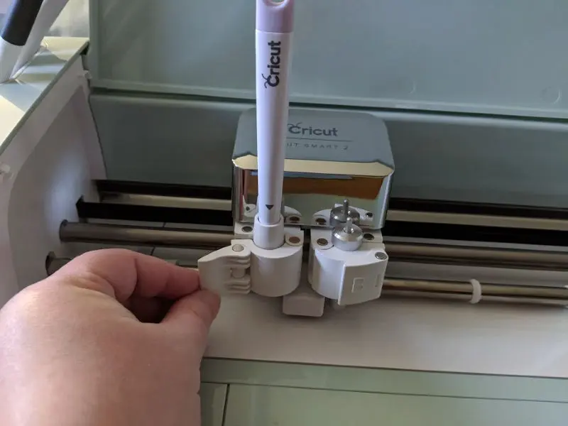 Close up of scoring stylus placed in Clamp A on Cricut Explore Air 2 machine.