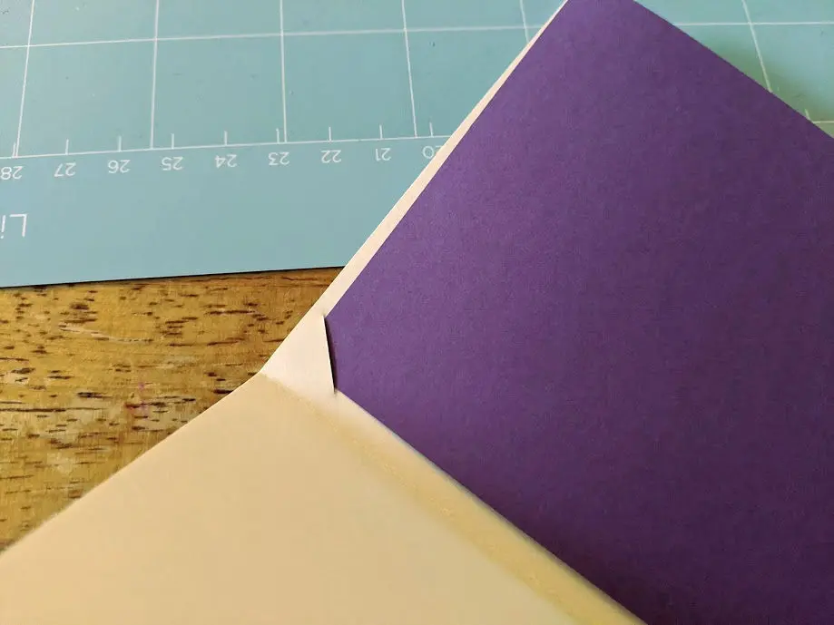 Adding purple cardstock insert into DIY birthday card.