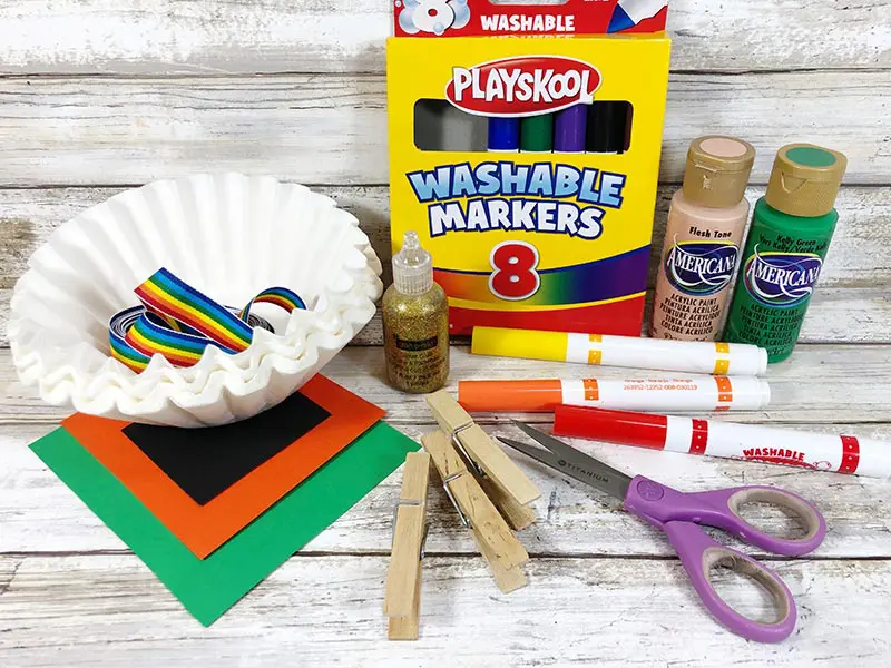 Colored paper, coffee filters, clothespins, markers, scissors, and paint.