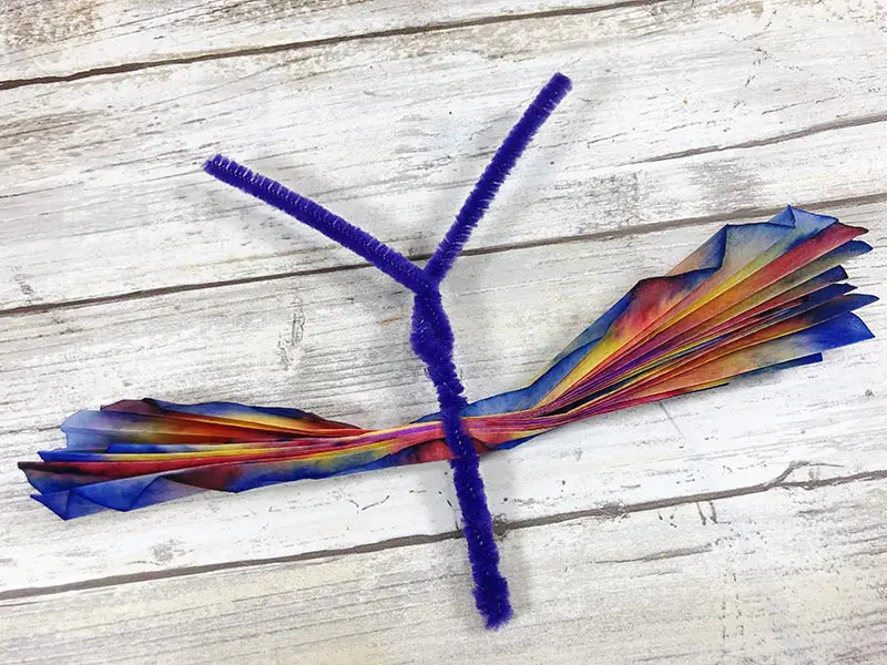 Chenille stem pipe cleaner twisted to create butterfly body.