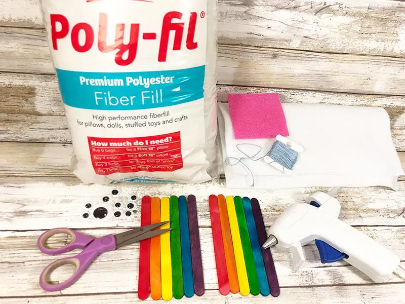 A bag of poly-fil, colored popsicle sticks, googly eyes, felt, scissors, and glue gun.