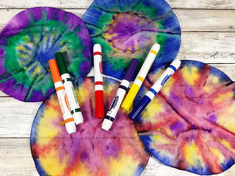 Four coffee filters tie dyed with markers.