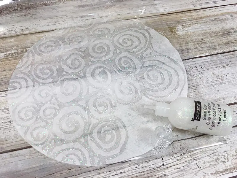 Glitter glue swirl pattern on white coffee filter.