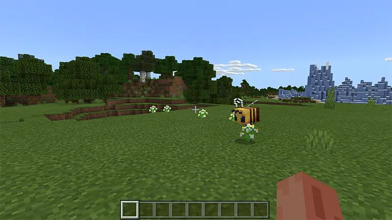 Bee landing on flower in grassy area in Minecraft