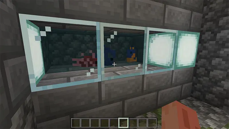 Fish tank built in stone wall using glass blocks in the game Minecraft.