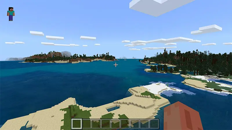 In game image from Minecraft character viewpoint in the sky, looking at water and different spots of land. Blocky clouds also in the sky.