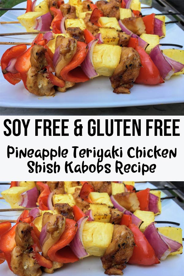 Grilled pineapple, red pepper, red onion, and chicken on bamboo skewers on a plate with text overlay Soy Free & Gluten Free Pineapple Teriyaki Chicken Shish Kabobs Recipe