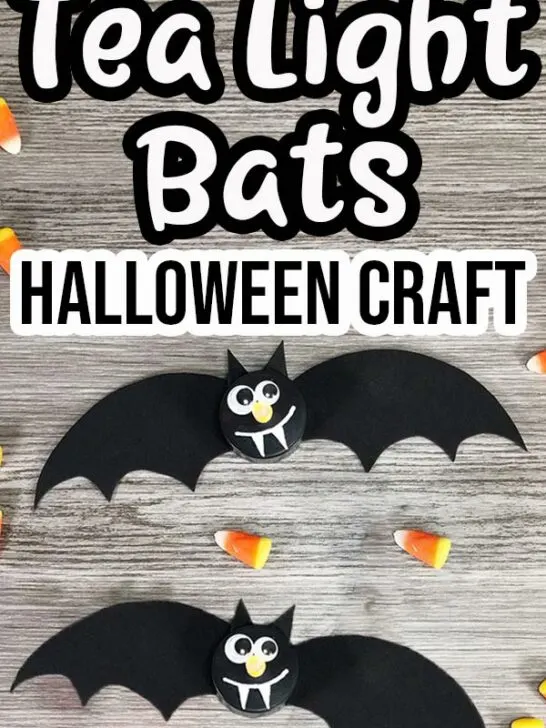 Two completed bats made with black flameless tea light candles on a gray wooden background with candy corn sprinkled around them. Text at top says Tea Light Bats Halloween Craft