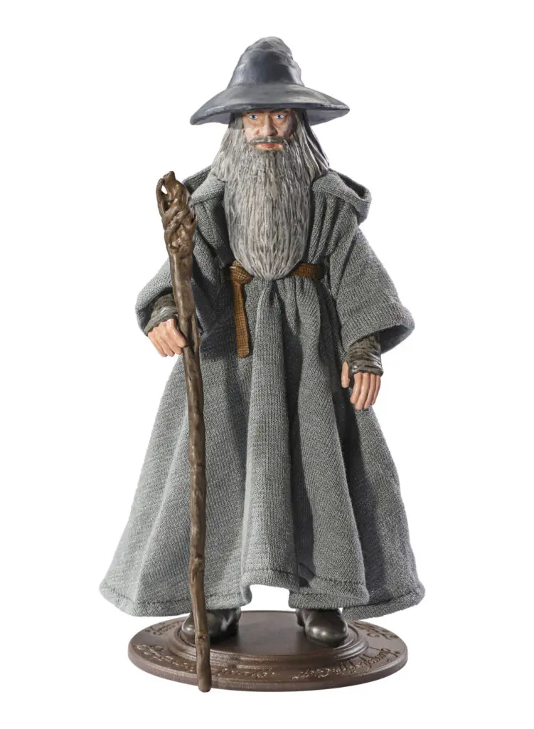 Gandalf posable figure in gray hat and robes holding staff and on stand base with white background.