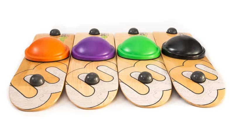 Four Whirly Boards laying side by side upside down showing the different color bottoms.