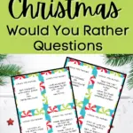 Printable is in white text on a red rectangle. Christmas Would You Rather Questions is in black text on a light green rectangle. Preview image of two pages of would you rather question cards on a white background with evergreen branches and a few small red stars.