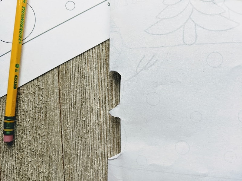 Printable snowman card folded in half with two parts of snowman's body folded inward at crease.