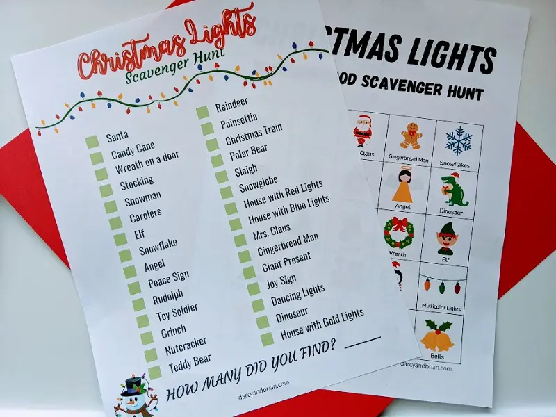 Two Christmas lights scavenger hunt pages printed out and laying overlapping each other on top of a piece of red cardstock.