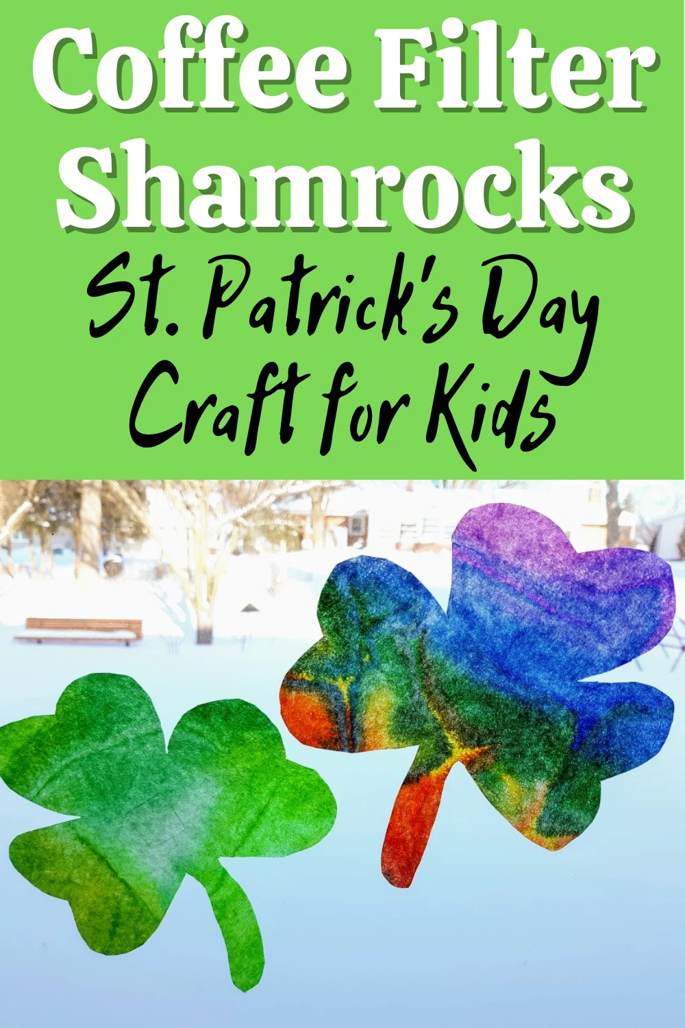 White and black text on green square on top half of image reads: Coffee Filter Shamrocks St. Patrick's Day Craft for Kids. Lower half of image shows one green and one rainbow tie dyed coffee filters cut into shamrock shapes in a bright wintery window.
