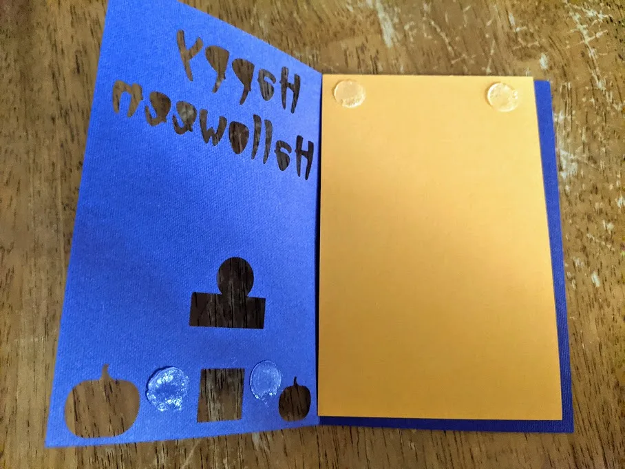 Glue dots on orange insert at top and on back of purple cardstock at bottom.