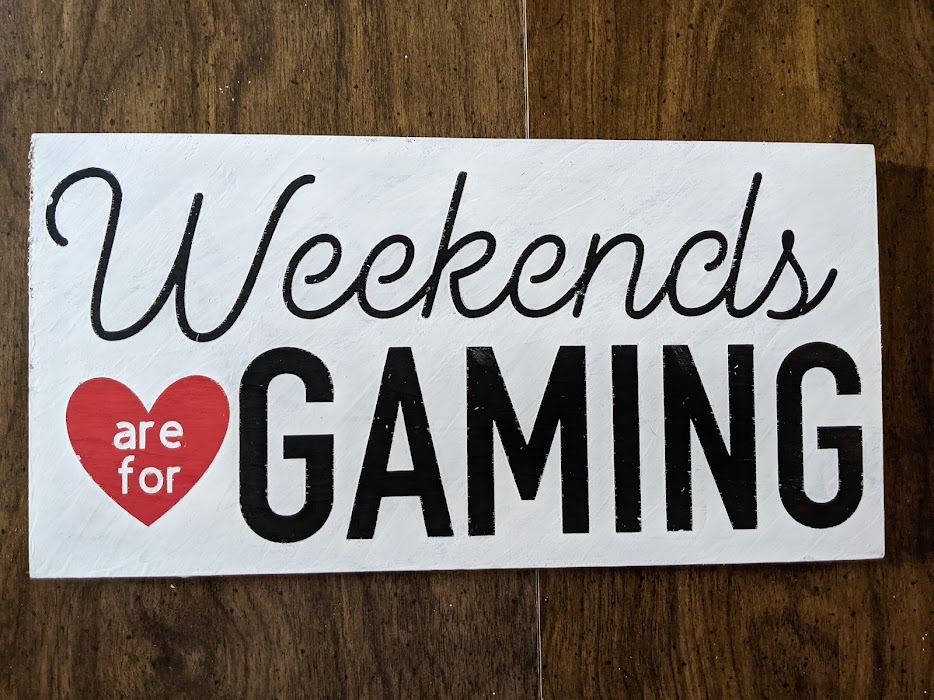 Finished wooden sign project with black painted words Weekend and Gaming. Red painted heart with white words inside "are and for" with white covering the rest of the sign. Weekends are for Gaming hand painted sign.