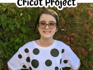 White tween girl wearing white tshirt with various black spots ironed on and black headband with black felt dog ears. Above picture is black text on white background that says DIY Dalmatian Costume Cricut Project.