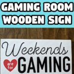 White text with black outline on bright cyan background reads DIY Gaming Room Wooden Sign. Below is picture of a wood sign painted white with black lettering and a red heart that says Weekends are for Gaming.