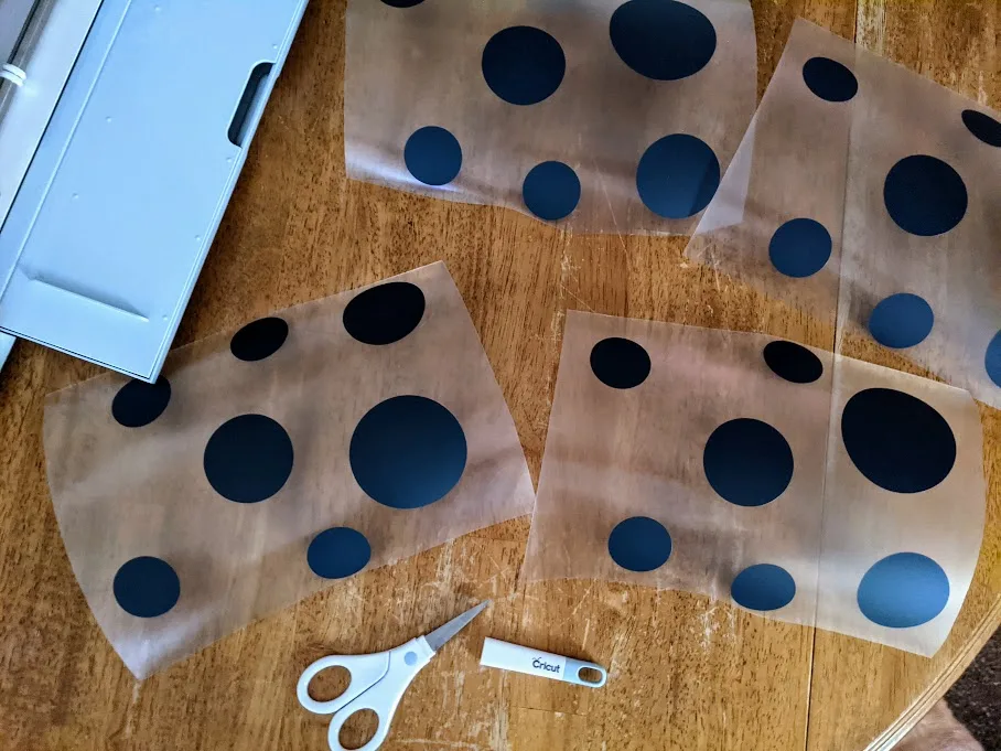 Iron on vinyl liner cut apart into groups of different sized spots.