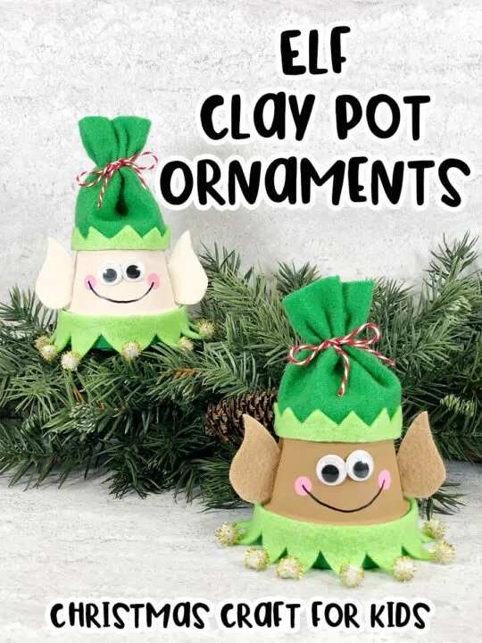 Black text at top reads Elf Clay Pot Ornaments. Black text at bottom reads Christmas Craft for Kids. Two finished elf clay pot crafts arranged by a garland of evergreen. One elf is painted with lighter skin tone and one is painted with darker skin tone. They are wearing green felt hats.