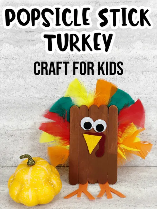 Black text at top says Popsicle Stick Turkey Craft for Kids above completed craft project of turkey made out of popsicle sticks, craft feathers and felt. Turkey sitting next to yellow gourd decoration.